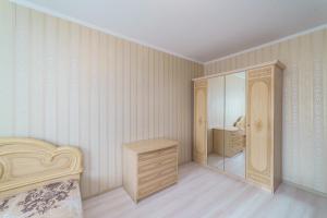 a bedroom with a bed and a dresser and a mirror at Притомский, 13 in Kemerovo