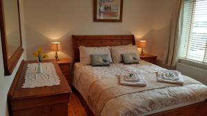 a bedroom with a bed with towels on it at Anchor Haven in Goleen