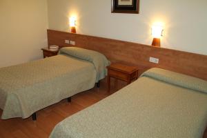 Postel nebo postele na pokoji v ubytování Hotel Flora Parc