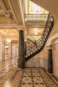 a large stairway leading to a large room at Hotel Bentley in Alexandria
