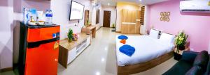 a hospital room with a bed and a refrigerator at Walking Street Residence - Boutique Suites near the Beach & Walking Street in Pattaya South