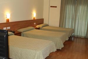 Postel nebo postele na pokoji v ubytování Hotel Flora Parc