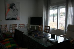 a living room with a table and a television at Mirador Tierra de Frontera in Alcalá la Real