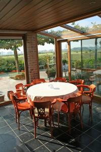 a dining room with a table and chairs at 't Leeg Huys in Lo-Reninge