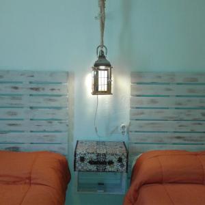 a bedroom with two beds and a light fixture at Granada Old Town Hostel in Granada