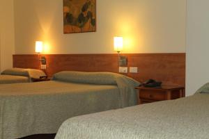 Postel nebo postele na pokoji v ubytování Hotel Flora Parc