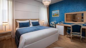 a bedroom with a large bed and a desk with a computer at VIP Rooms in Split