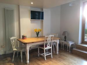 a dining room with a wooden table and chairs at Batley House in Westgate-on-Sea