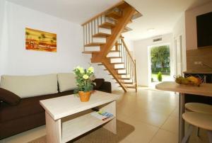 a living room with a couch and a staircase at Pod Muzami in Rewal
