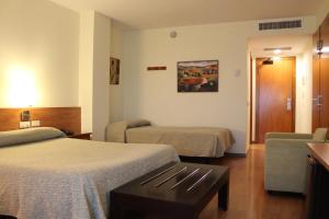 Postel nebo postele na pokoji v ubytování Hotel Flora Parc