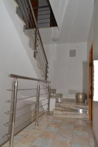 a staircase in a building with a metal railing at House Gonçalves in Praia