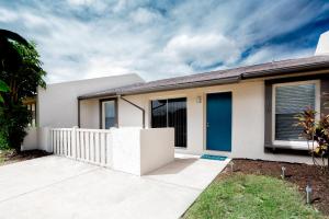 a white house with a blue door at Oasis Villa Retreat in Bradenton