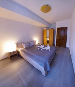 a dog laying on a bed in a bedroom at Vitan Residence in Bucharest