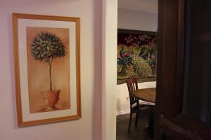 a painting of a flower in a vase next to a table at Comfy Cozy Affordable Home Away Home in Garland