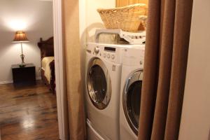 a washer and dryer with a basket on top of it at Comfy Cozy Affordable Home Away Home in Garland