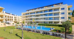 a hotel with a swimming pool in front of a building at Laguna - Vilamoura in Vilamoura
