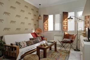 a living room with a couch and a table at Apartamentos Mirador Alhambra in Granada