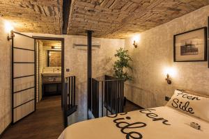 een slaapkamer met een bed en een hal met een badkamer bij Imagine Budapest Loft Apartments in Boedapest