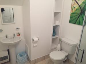 a white bathroom with a toilet and a sink at Room 3 Camp Street B&B in Oughterard