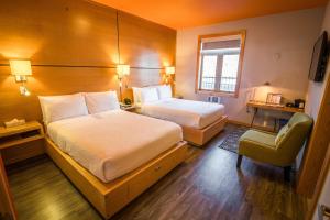 Voodi või voodid majutusasutuse Adventure Hotel toas
