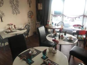 a dining room with tables and chairs and a window at The Bay - rooms only in Margate