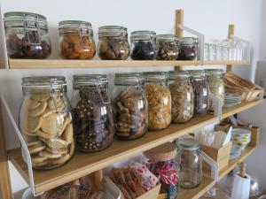 a pantry filled with lots of jars of food at B&B Porta del Re in Taormina