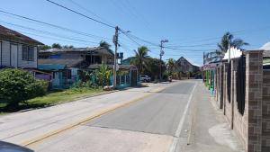 an empty street in a small town with houses at Miss Leila in San Andrés