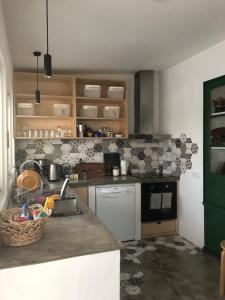 a kitchen with a sink and a counter top at Hostel do Mar in Carrapateira
