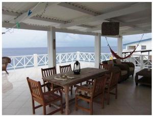 a living room with a table and chairs and the ocean at Dolphin Hearthouse in Lagun