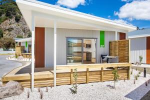a rendering of a house with a wooden deck at Awa Motel in Whakatane
