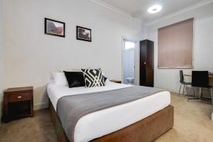 a bedroom with a bed and a desk at Royal Hotel Gympie in Gympie