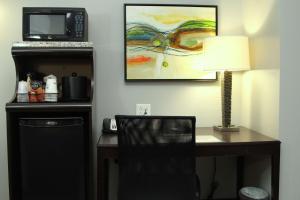 a kitchen with a table and a lamp at Best Western Plus Olathe Hotel in Olathe