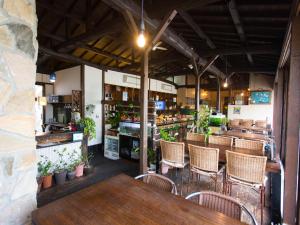a restaurant with tables and chairs in a room at Hotel AreaOne Sakaiminato Marina in Sakaiminato