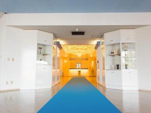 a hallway with a blue carpet in a room at Hotel AreaOne Sakaiminato Marina in Sakaiminato