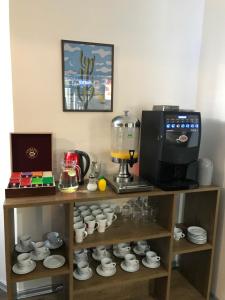 a shelf with a blender and cups and a coffee maker at Penzion Ema B&B in Prostějov