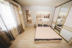 a bedroom with two beds and a window at ATLANT Apartments 109 in Voronezh
