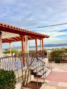 a building with a porch with a bench on it at sea view countryside home near Athens in Nea Peramos