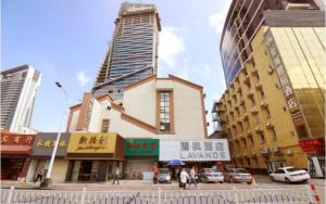 a group of buildings in a city with cars at Lavande Hotel Zhuhai Gongbei Port Square in Zhuhai