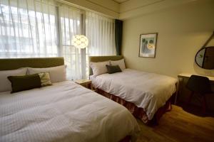 Postel nebo postele na pokoji v ubytování Sakagami Hotel