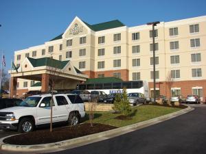 a white vehicle parked in front of a building at Country Inn & Suites by Radisson, BWI Airport Baltimore , MD in Linthicum Heights