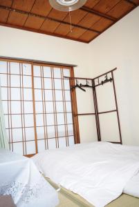 Un pat sau paturi într-o cameră la Guest House Aki