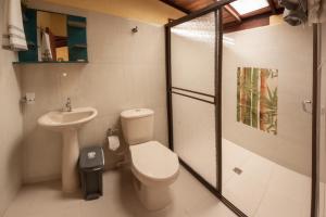 a bathroom with a toilet and a sink and a shower at La Divina Providencia in Jardin