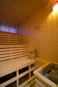a sauna with a bench and a sink in it at Boutique Hotel Victoria Budapest in Budapest