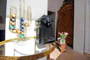 a glass table with a coffee maker on top of it at Vondelpark Suite in Amsterdam