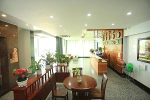 a restaurant with a table and chairs in a room at Phuong Linh Hotel in Danang