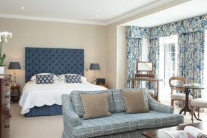a bedroom with a large bed and a large window at Longueville Manor in Saint Helier Jersey
