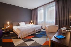 Postel nebo postele na pokoji v ubytování Vulcan Hotel
