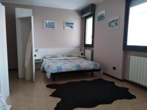 a bedroom with a bed and a rug at Airport Orio Studio in Bergamo