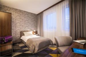 Postel nebo postele na pokoji v ubytování Vulcan Hotel