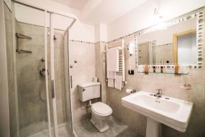 a bathroom with a toilet and a sink and a shower at Hotel Victoria in Taormina